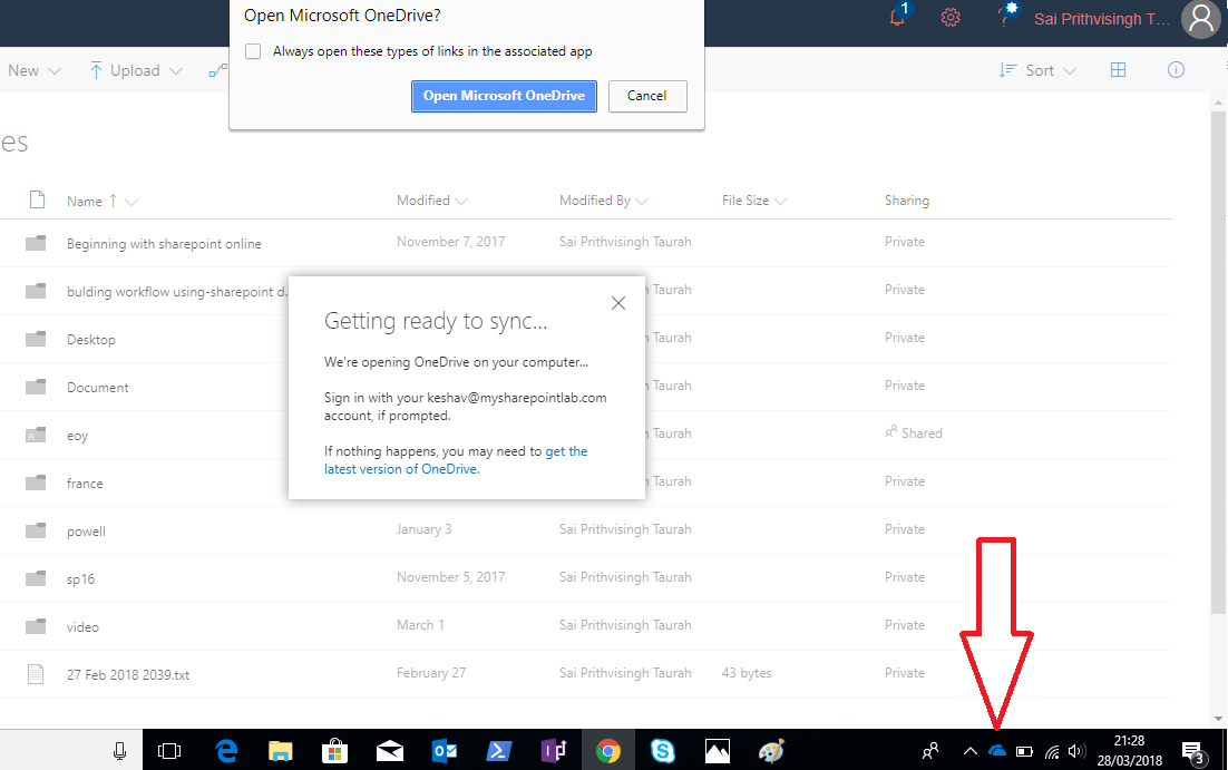 Locate the OneDrive symbol in the system tray area